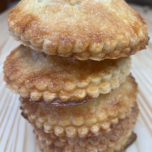 Four small fruit pies stacked on top of one another